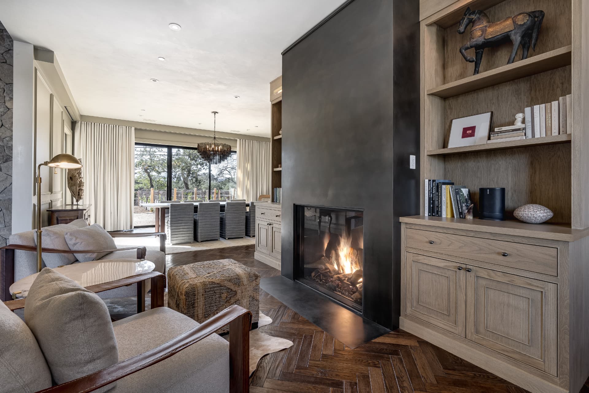 Wine country great room with steel fireplace and herringbone oak floors