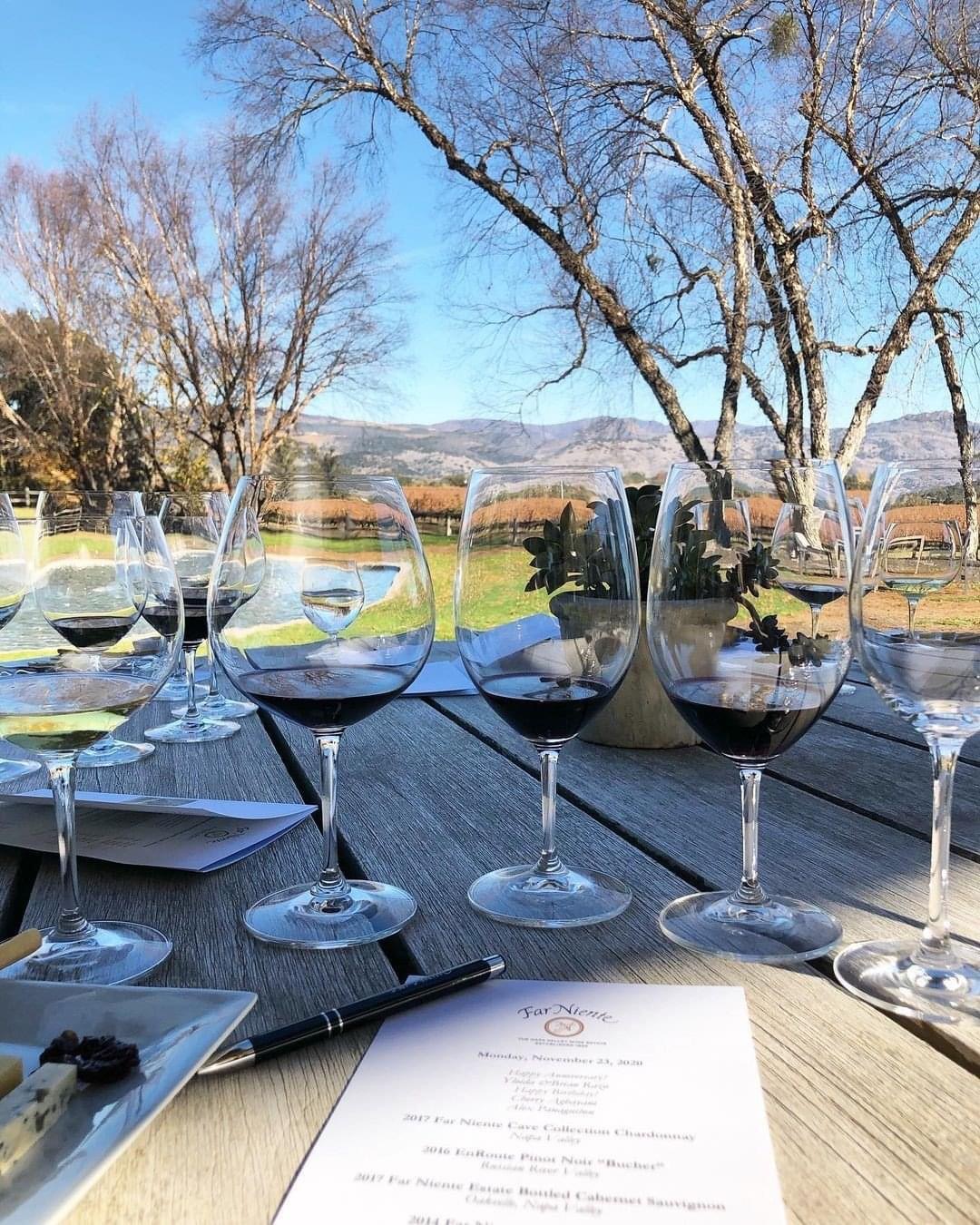 Wine tasting flight on a terrace overlooking Napa Valley vineyards and hills