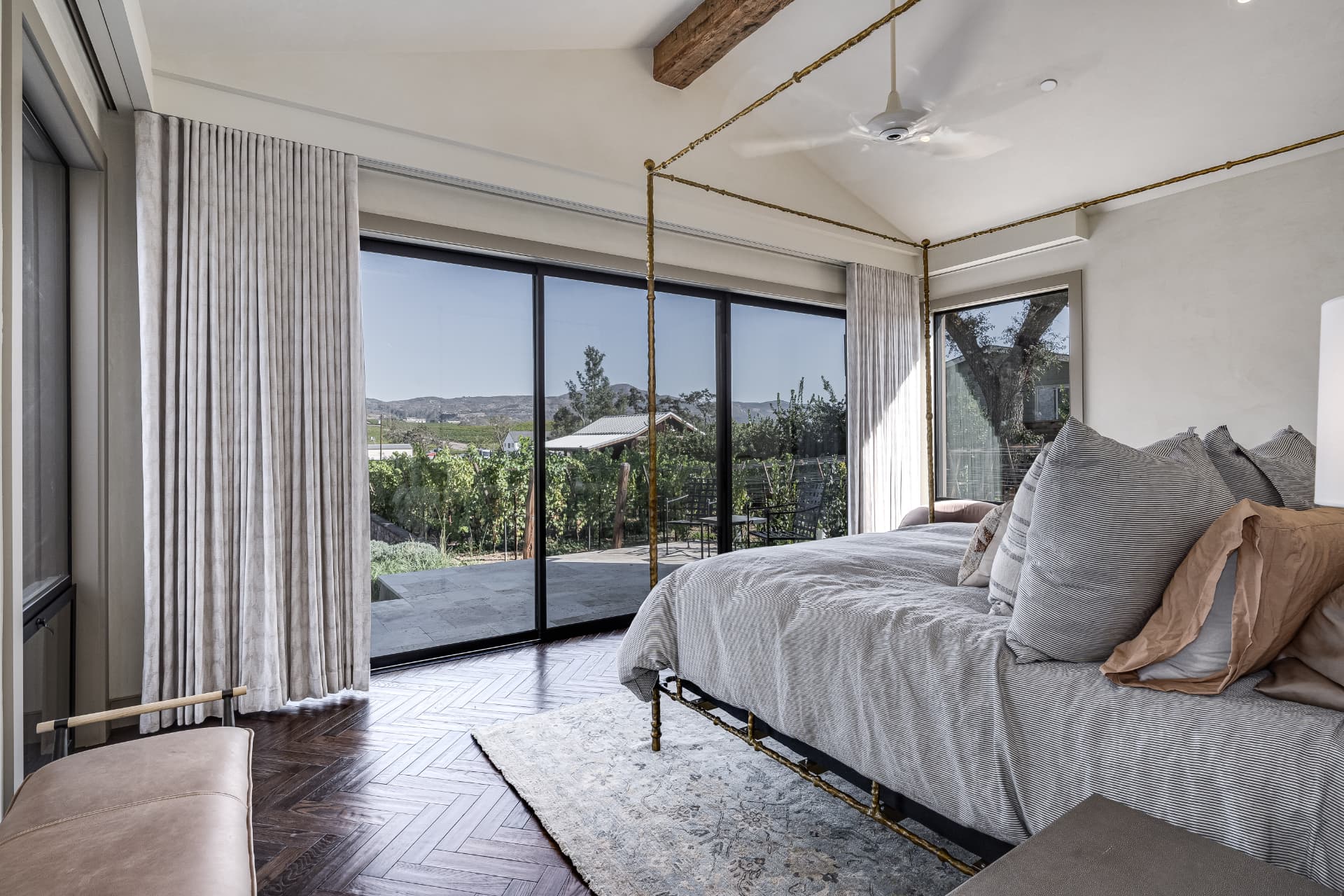 Primary suite opening to a terrace above Napa Valley vineyards