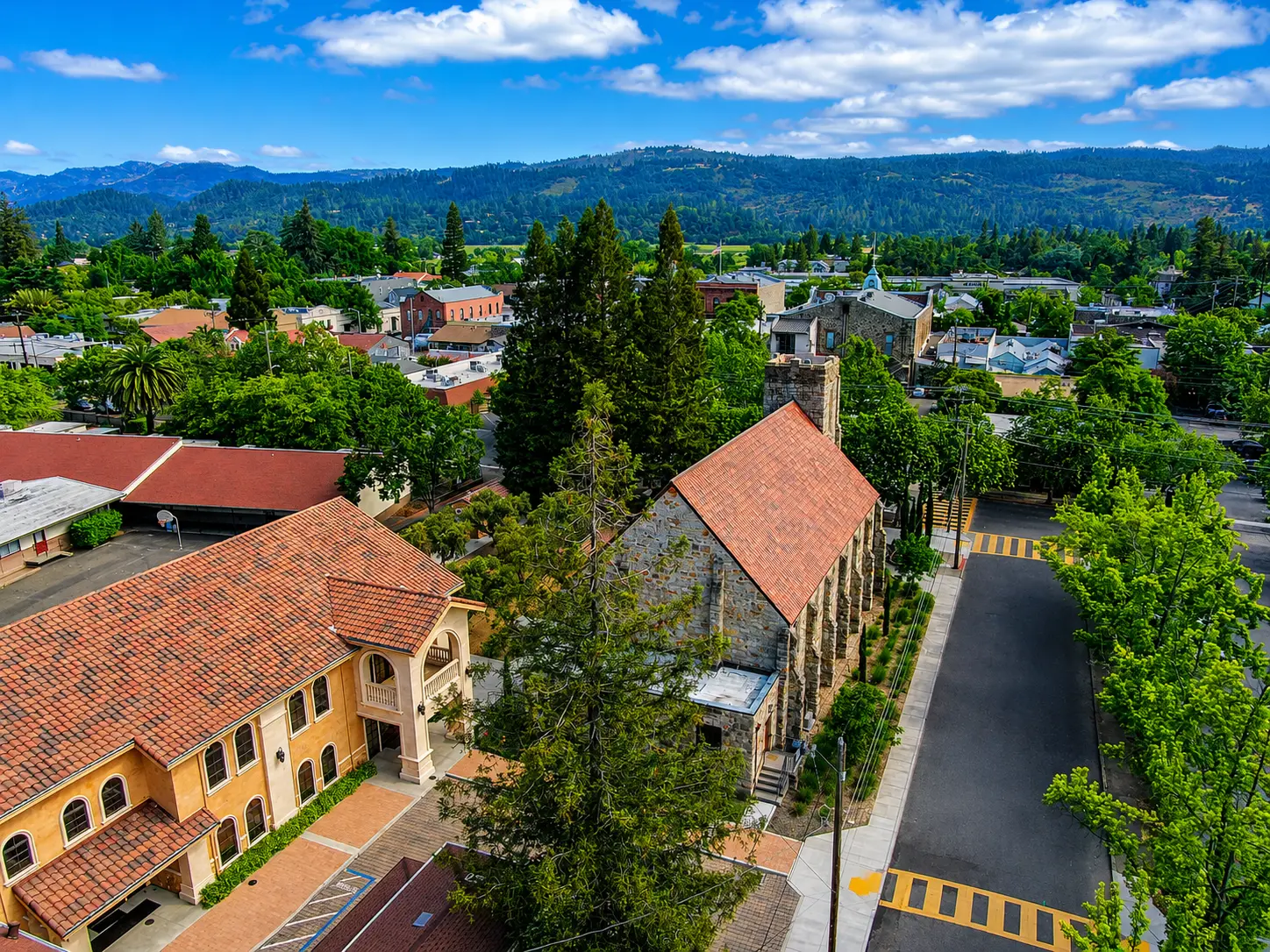 Aerial view of historic downtown Saint Helena, CA with stone church and hills beyond