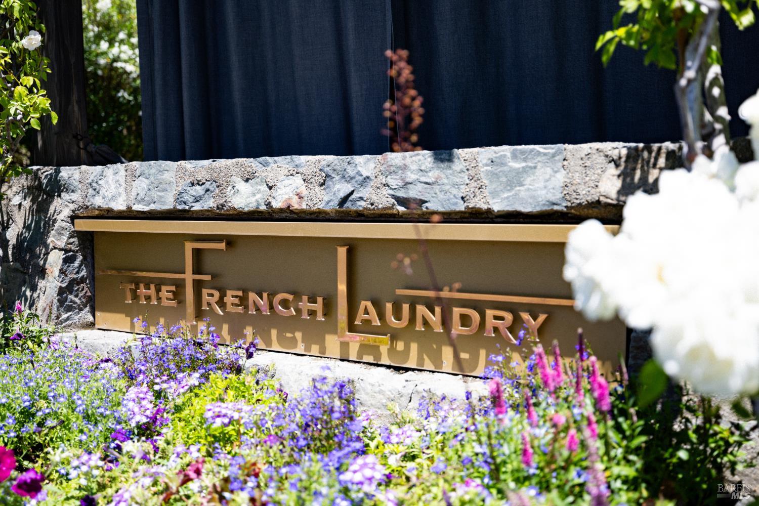 The French Laundry entrance sign framed by flowers in Yountville, Napa Valley